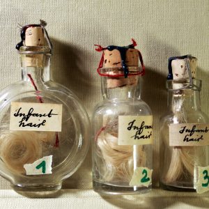 Infant hair in a vintage vial