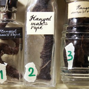 A piece of a hanged man’s old rope in a vintage vial