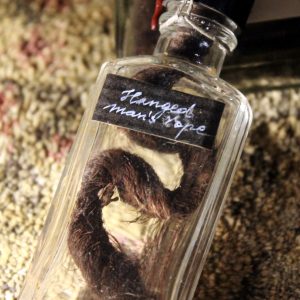 A piece of a hanged man’s old rope in a vintage vial
